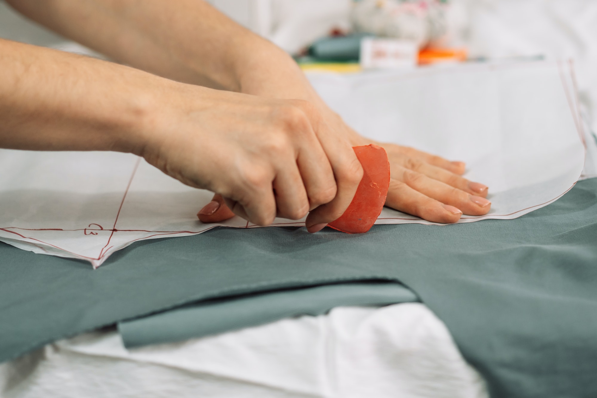 lady-draws-patterns-on-the-fabric-with-chalk.jpg